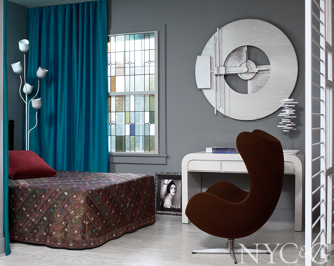 Velvet chair and curtains decorate master bedroom