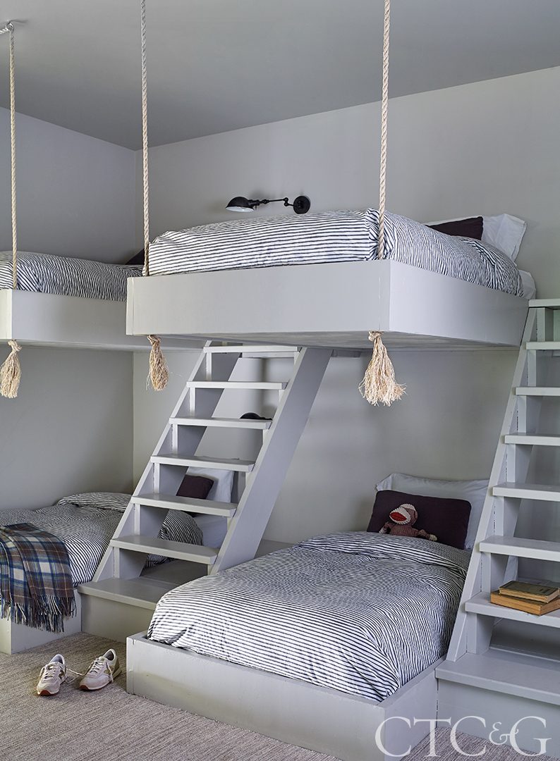 Kids bedroom with floating bunk beds and striped bedding