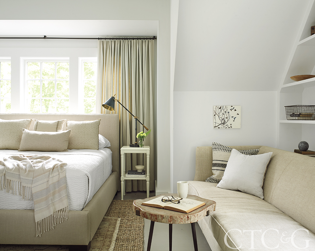 Beige and white bedroom with couch and coffee table