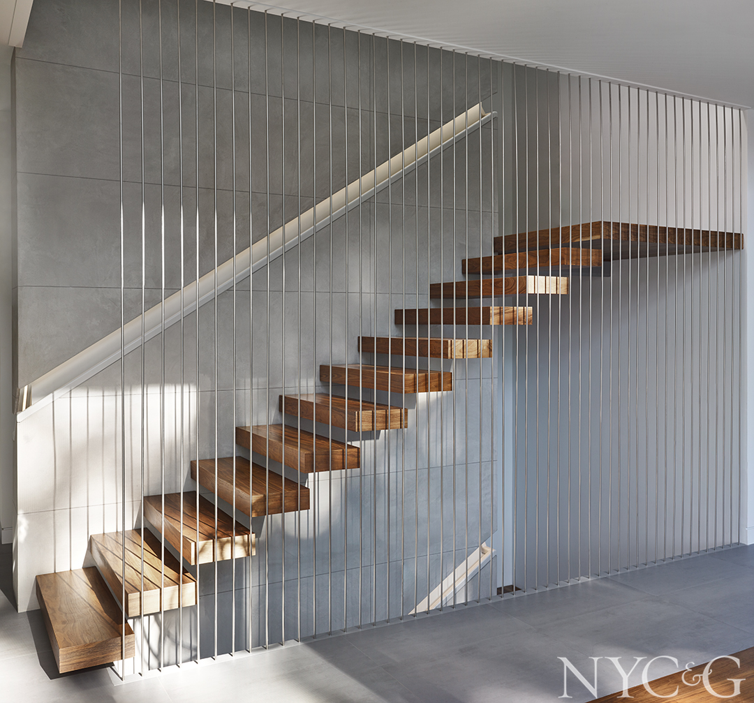 Contemporary staircase with walnut treads and stainless-steel rods