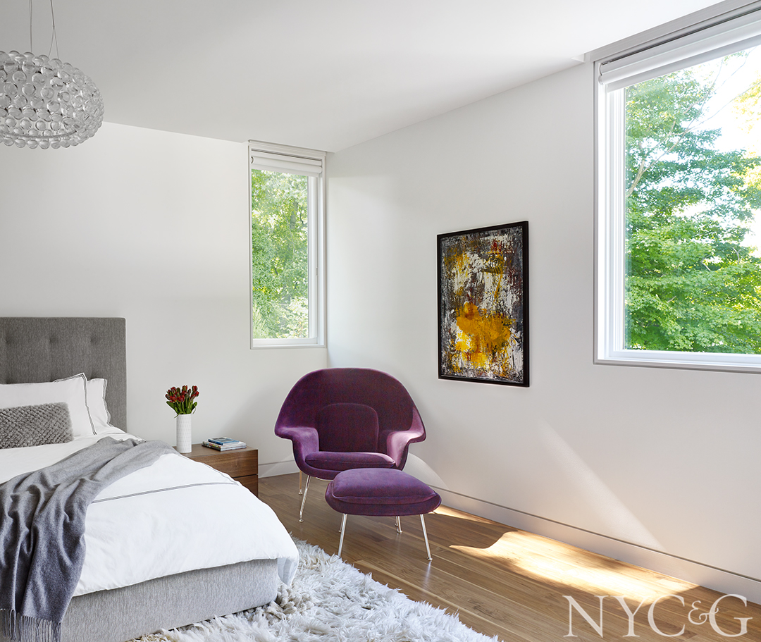 A purple chair adds color to master bedroom
