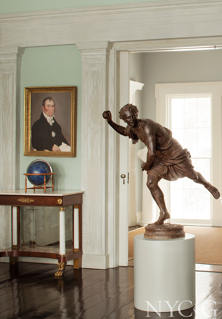 Portrait and statue decorate hallway