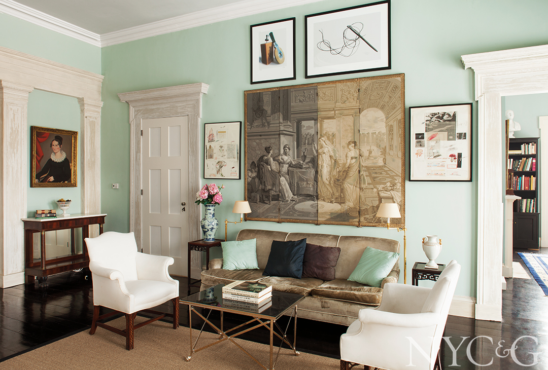 Collage of prints hang over seating area
