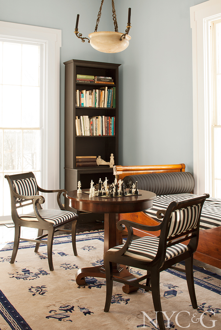 Antique Chinese rug decorates the library/game room